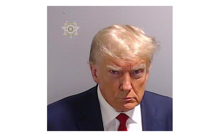 Former President Donald Trump poses for his booking photo at the Fulton County Jail on Thursday, Aug. 24, 2023, in Atlanta.