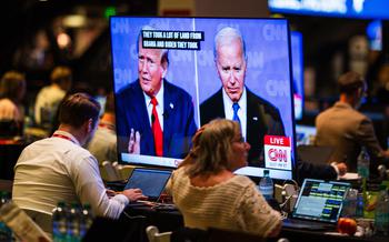 Inside the press filing center in Atlanta on June 27, a television shows the first presidential debate of the 2024 election cycle between former president Donald Trump and President Biden. 