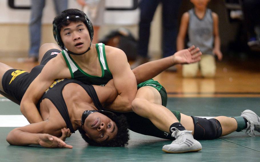 Kubasaki 127-pounder Gavin Ocampo gains the upper hand on Kadena's Josiah Drummer during Wednesday's Okinawa wrestling dual meet. Ocampo pinned Drummer in 1 minute, 17 seconds, but the Panthers won the meet 35-26 to go 2-0 on the season.