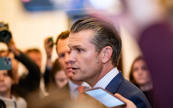 President-elect Donald Trump’s nominee for secretary of defense, Pete Hegseth, is seen surrounded by reporters and onlookers.