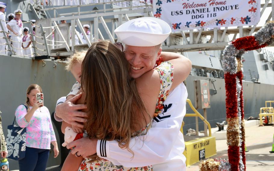 Cryptologic Technician Technical 2nd Class Tad Holm hugs his family