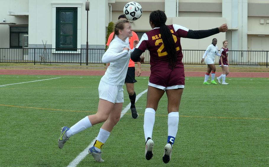 E.J. King's Madylyn O'Neill and Matthew C. Perry's Aisha Nurudin-Watley go up to head the ball during Saturday's DODEA-Japan girls soccer match. The Cobras won 2-0.
