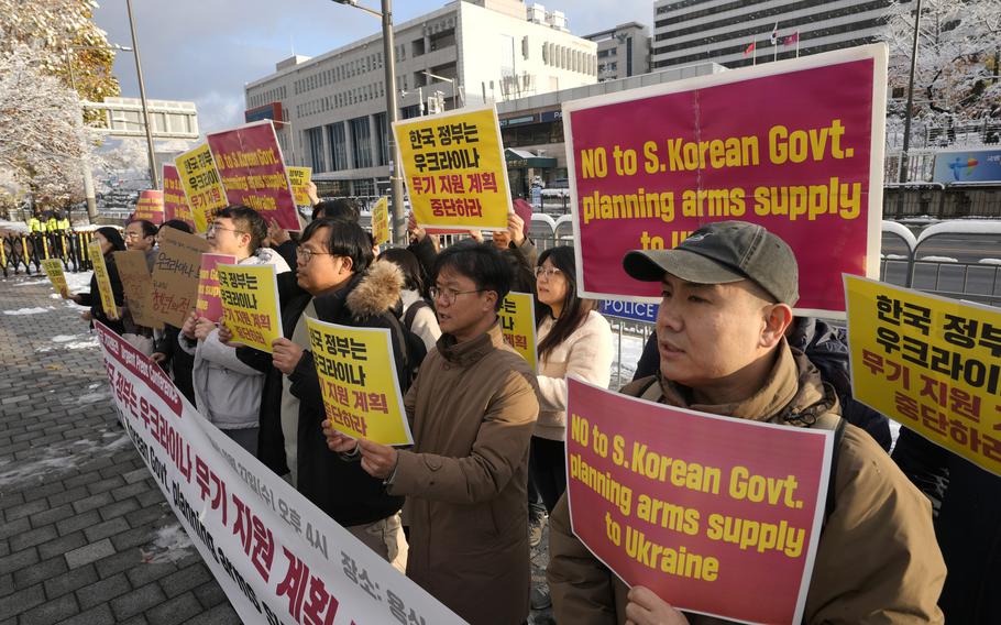 South Korean protesters hold signs expressing disapproval of their government’s plan to give military aid to Ukraine. Three signs read “NO to S. Korean Govt. planning arms supply to Ukraine.”