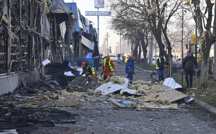 City workers cleaning a street in Odesa, Ukraine after a drone attack.