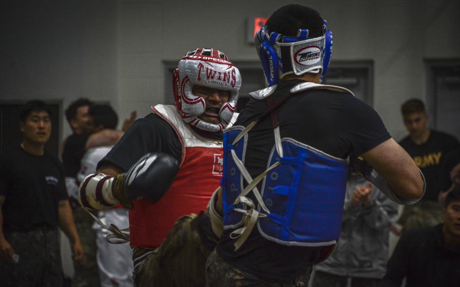 Two military members engage in a match during a taekwondo exhibition in Carey Fitness Center at Camp Casey, South Korea, on June 8, 2024