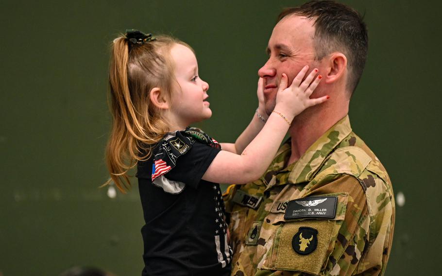 Soldier plays with child