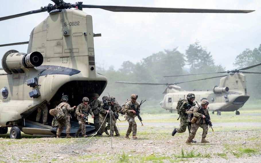 U.S. and Japanese soldiers move out of a CH-47 Chinook during an Orient Shield air assault exercise at Aibano Training Area, Japan, July 22, 2024. 