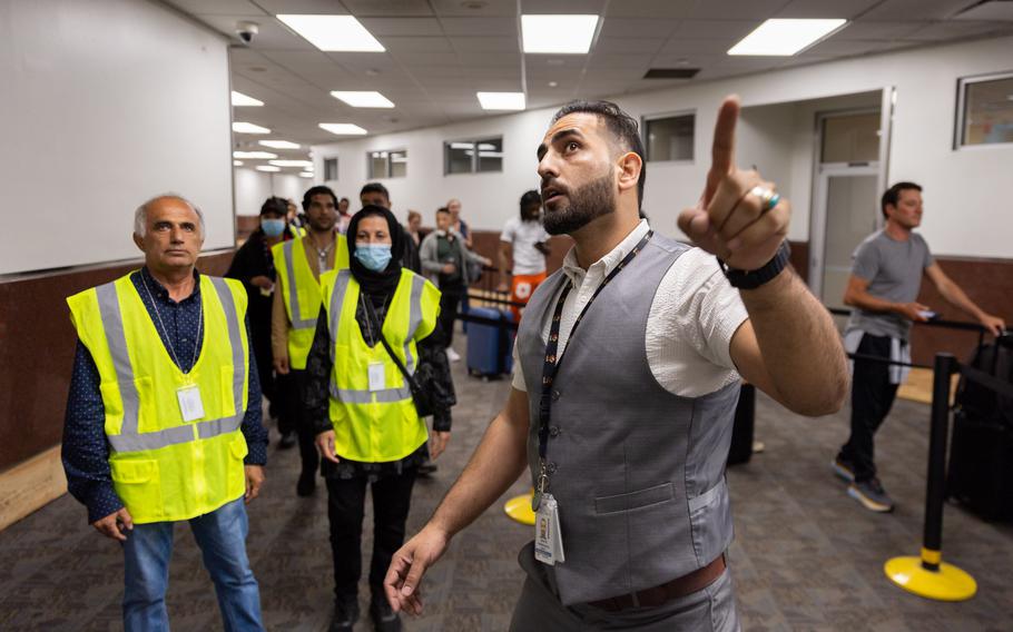 Mirwais Jalali, a recruiter for aviation contractor Unifi, gives new employees a tour of the Hartsfield-Jackson airport in Atlanta on Friday, April 19, 2024.