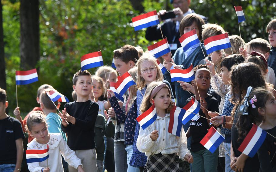 Dutch schoolchildren line a street in Mesch, Netherlands, on Thursday, Sept. 12, 2024, to welcome King Willem-Alexander, Queen Maxima and U.S. World War II veteran Kenneth Thayer to a commemoration marking 80 years since U.S. troops liberated the village from the Nazis.