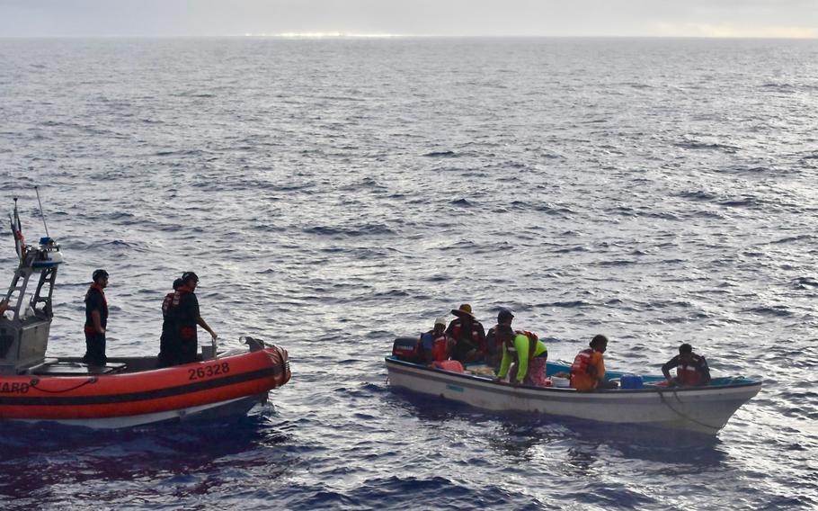 The crew of the U.S. Coast Guard cutter Oliver Henry visit with residents of Satawal, Federated States of Micronesia, after safely returning six rescued fishermen and their 22-foot fiberglass boat to the community on Aug. 18, 2024. 