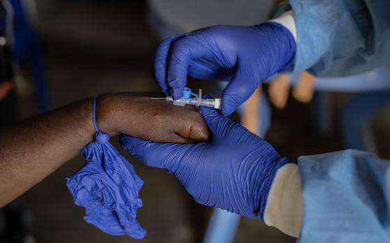 FILE - A health worker attends to a mpox patient, at a treatment centre in Munigi, eastern Congo, Aug. 16, 2024. (AP Photo/Moses Sawasawa, file )