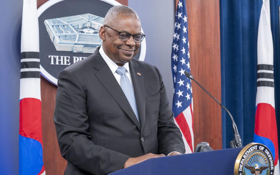 Lloyd Austin stands at a podium in front of the Pentagon emblem.