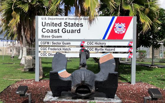 Palm trees are in the background with a sign denoting a U.S. Coast Guard base.