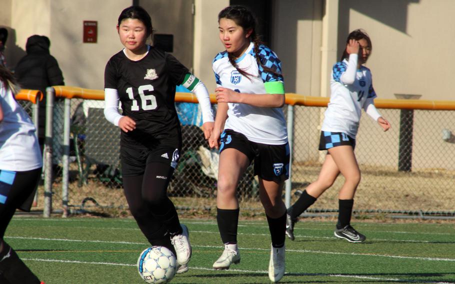 Osan’s Clarice Lee dribbles against Daegu’s Gina Kim during Friday’s Korea girls soccer match. The Cougars won 5-2.