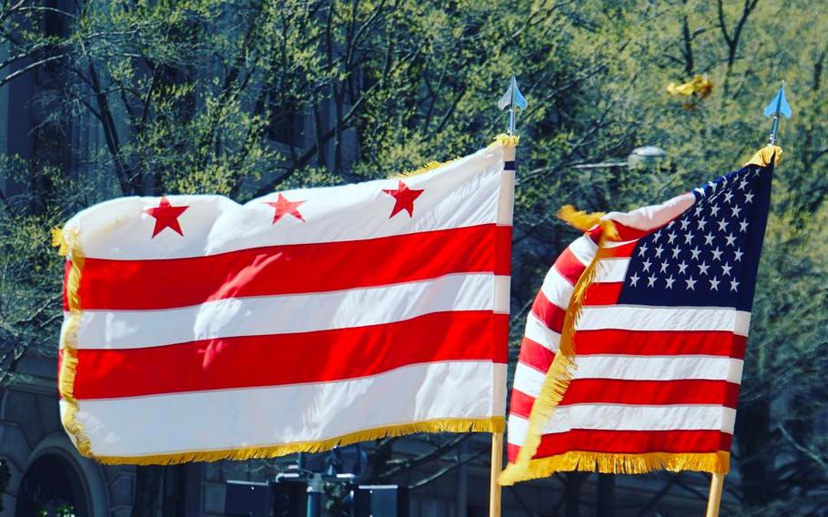 A photo of the DC flag and the United States flag.