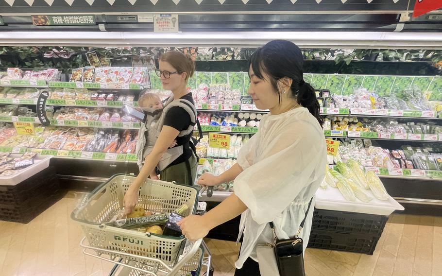 Akemi Kikugawa of the Japanese American Society helps Marine Corps spouse Camille Williamson shop at a Japanese grocery store near Marine Corps Air Station Iwakuni, Japan, Sept. 17, 2024. 