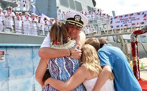 Cmdr. Kevin Dore, commanding officer of the Arleigh Burke-class guided-missile destroyer USS Daniel Inouye (DDG 118), hugs his family during the return to homeport celebration at Joint Base Pearl Harbor-Hickam, Hawaii, Oct. 4, 2024. Daniel Inouye, part of the Theodore Roosevelt Carrier Strike Group, promoted regional stability and security, deterred aggression, and protected the free flow of commerce throughout its nine-month deployment. An integral part of U.S. Pacific Fleet, U.S. 3rd Fleet leads naval forces in the Indo-Pacific and provides the realistic, relevant training necessary to flawlessly execute our Navy’s role across the full spectrum of military operations—from combat operations to humanitarian assistance and disaster relief. U.S. 3rd Fleet works together with our allies and partners to advance freedom of navigation, the rule of law, and other principles that underpin security for the Indo-Pacific region. (U.S. Navy photo by Ensign Paula Hackbart).