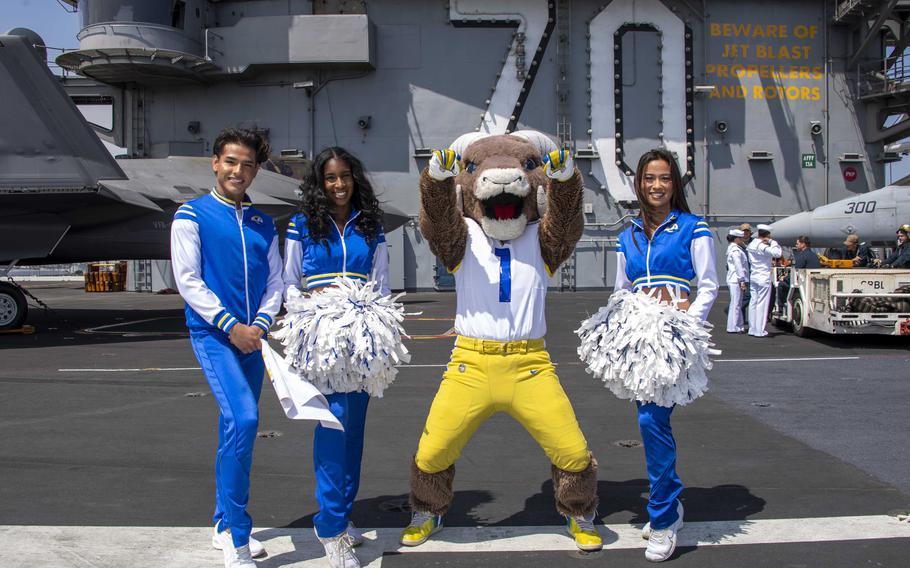 Los Angeles Rams cheerleaders and “Rampage,” the team mascot, pose on the flight deck aboard Nimitz-class aircraft carrier USS Carl Vinson (CVN 70) in support of Los Angeles Fleet Week on Wednesday, May 22, 2024. 