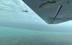 A Chinese military helicopter flies close to a Philippine Bureau of Fisheries and Aquatic (BFAR) aircraft above Scarborough shoal on Tuesday, Feb. 18, 2025. (AP Photo/Joeal Calupitan)