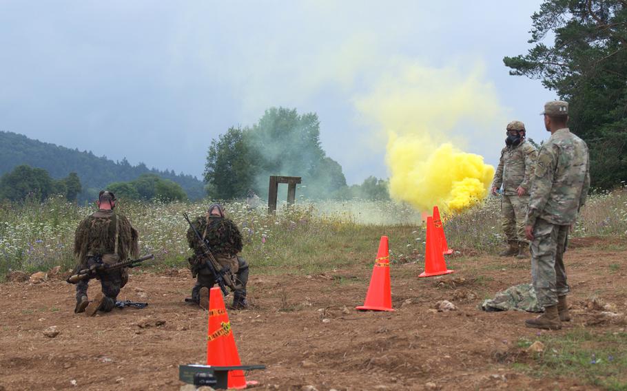 A pair of French snipers don gas masks as they prepare to clear a tear-gas filled trench during the eighth annual European Best Sniper Team Competition on Aug. 8, 2024, at the Joint Multinational Readiness Center in Hohenfels, Germany.