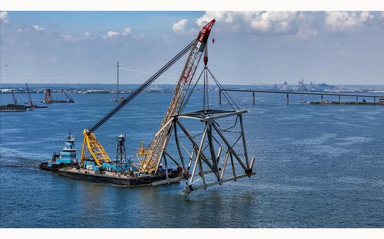 The Chesapeake 1000 crane barge carries the last large piece of the Francis Scott Key Bridge blocking the main shipping channel towards Tradepoint Atlantic on Tuesday, June 4, 2024, in Baltimore. (Jerry Jackson/Baltimore Sun/TNS)