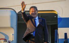Chinese Premier Li Qiang waves on his arrival at Adelaide Airport, Australia, on June 15, 2024.