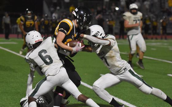 A trio of Naples tacklers, including Diondre Tilo, right, and Jeramiah Robinson stop Vicenza's Austin Perry from gaining any more ground Friday, Sept. 20, 2024.

Kent Harris/Stars and Stripes