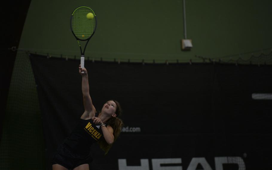 Vicenza's Delia Gordon delivers a focused serve against her opponent, Isabel Williams, during the DODEA European tennis championships at T2 Sports Health Club in Wiesbaden, Germany, on Oct. 21, 2023.