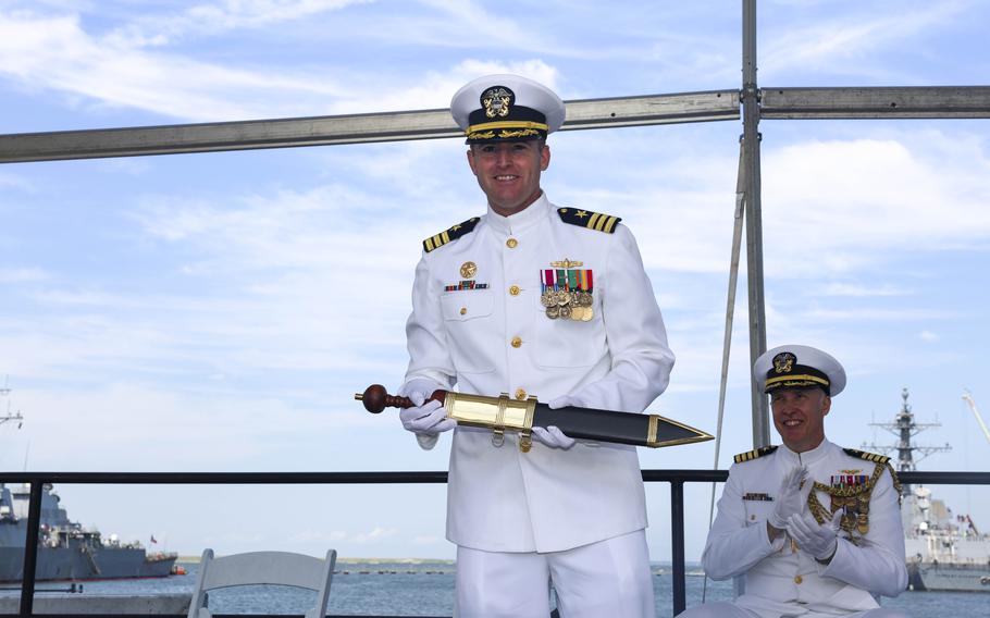 Cmdr. Christopher M. Stolle, the commanding officer, poses with a ceremonial gladius during the decommissioning ceremony of the guided-missile cruiser USS Vicksburg (CG 69), June 28, 2024, in Norfolk, Va.