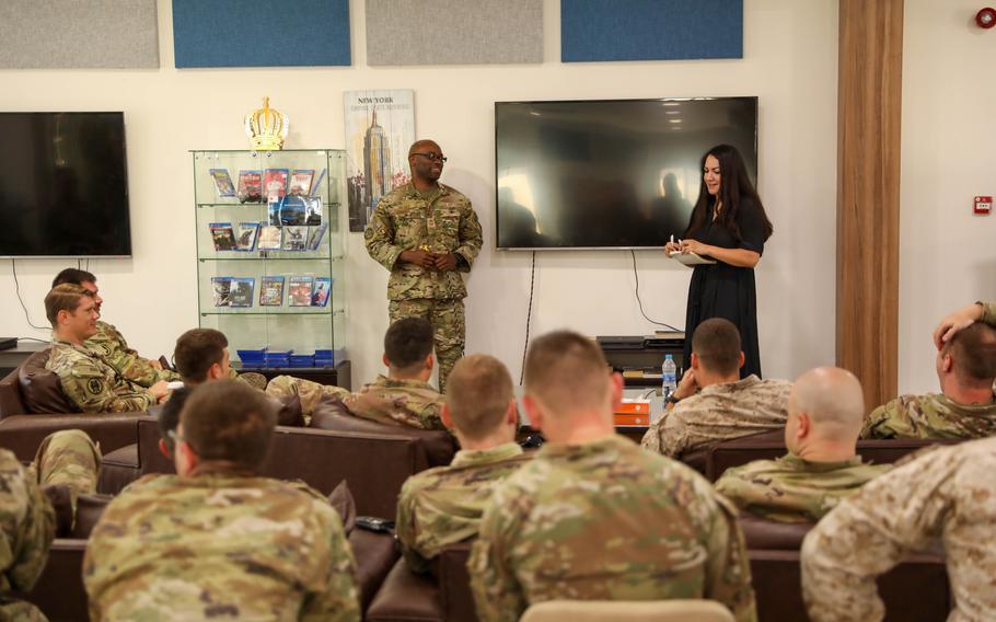 Air Force Chief Master Sgt. Brian Holmes and Lucy De La Mora, center manager for the USO, answer questions from troops in Jordan in September 2023 about junior enlisted services. 