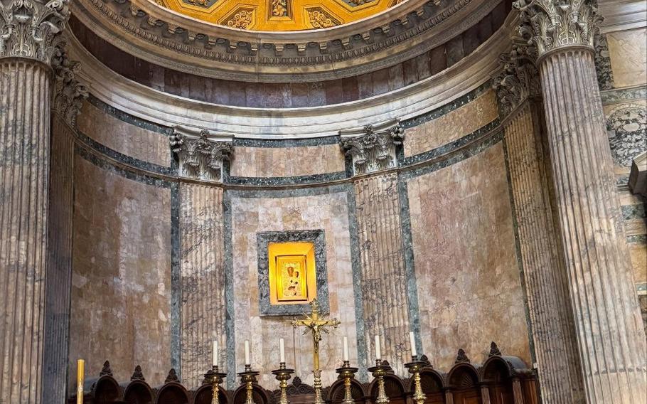 Gold painted circular ceiling, elaborately decorated.