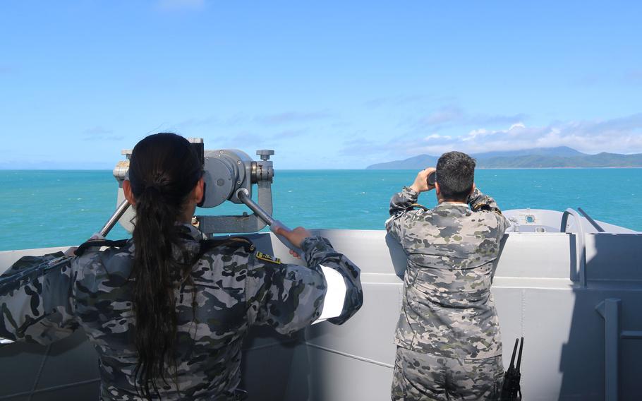 Australian navy sailors aboard the guided-missile destroyer HMAS Brisbane scan the horizon during search-and-rescue efforts near Lindman Island in Queensland, Australia, Saturday, July 29, 2023. 