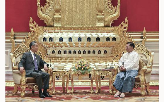 This photo provided by Myanmar Military Information Team, Myanmar's military leader Senior Gen. Min Aung Hlaing, right, chairman of State Administration Council, talks with Chinese Foreign Minister Wang Yi, during their meeting Wednesday, Aug. 14, 2024, in Naypyitaw, Myanmar. (Myanmar Military Information Team via AP)