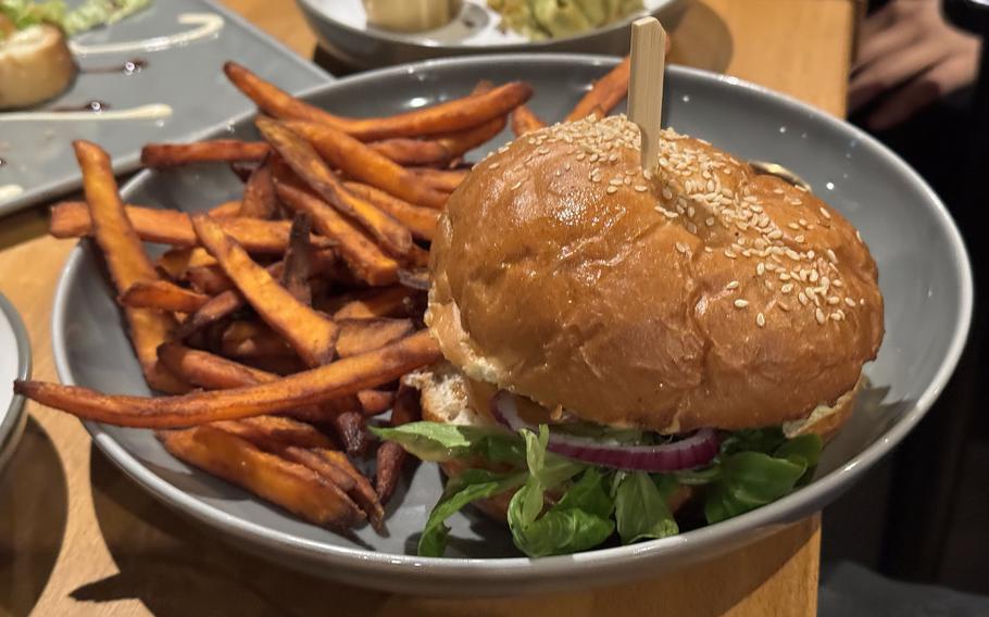 A burger and fries on a plate.