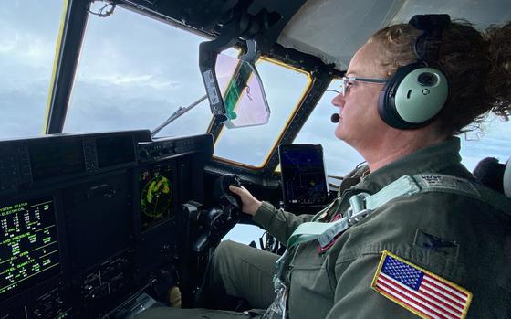 The commander of the 403rd Operations Group is seen at the controls of her plane as she flies into Hurricane Milton to gather weather data.