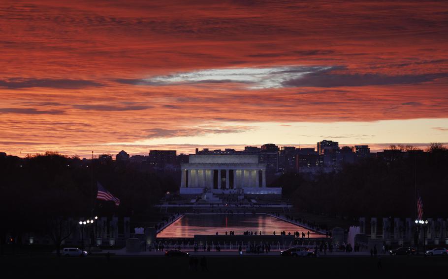 Orange skies above the Lincoln Memorial also show in the reflecting pool in front at sunset.