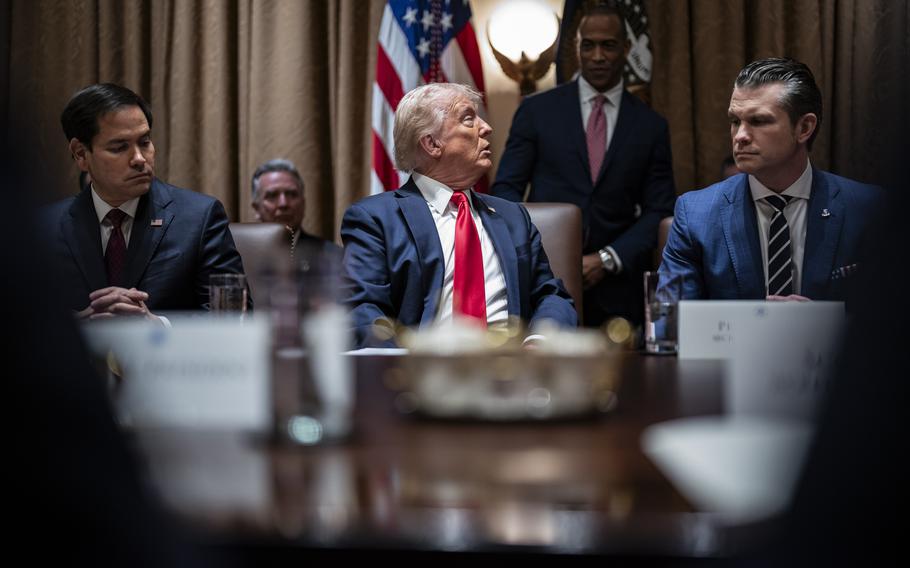 Donald Trump, flanked by Marco Rubio and Pete Hegseth, looks at Scott Turner.