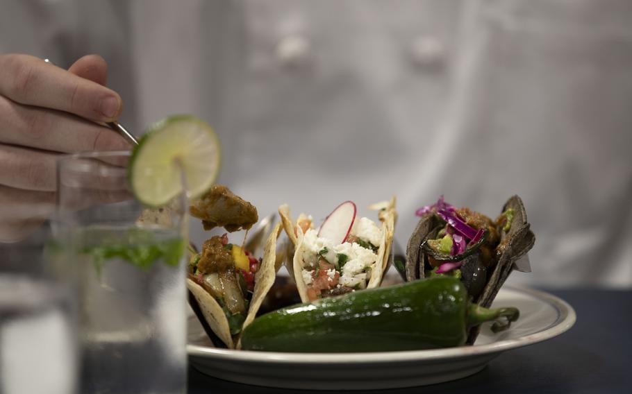 Chef Tyler Florence, applies salsa to a taco