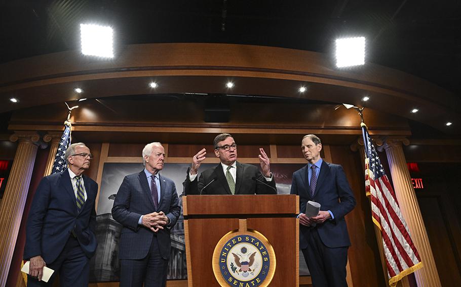 From left, Sens. Jerry Moran, R-Kan.., Sen. John Cornyn, R-Texas, Mark R. Warner, D-Va., and Ron Wyden, D-Oregon, attend a briefing on Capitol Hill in Washington, D.C., in May 2023.