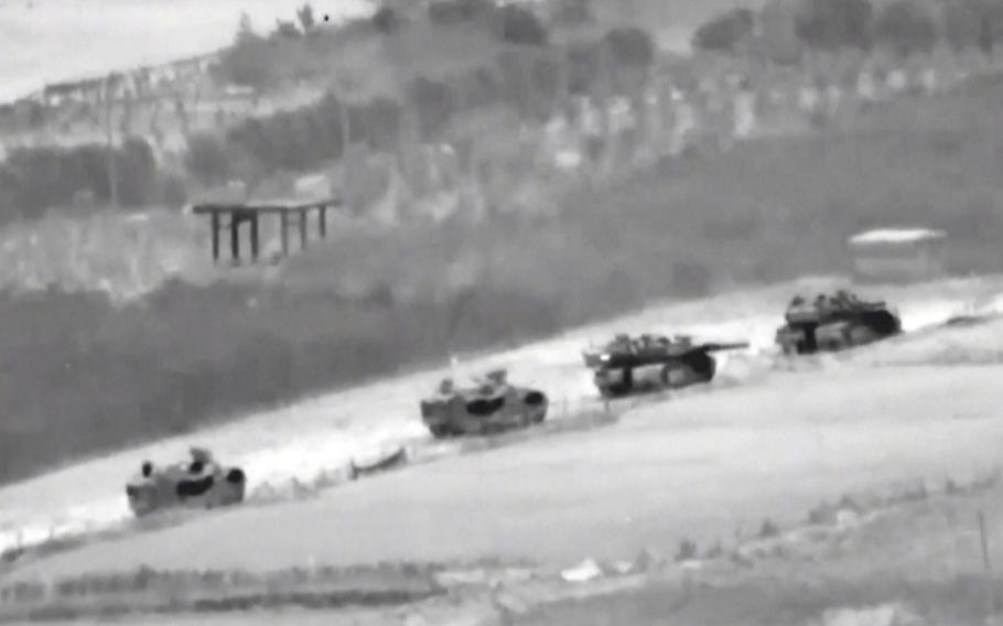 In this undated image taken from video released by Israeli Defense Forces, a line of Israeli tanks is shown during an incursion into the Gaza Strip. 