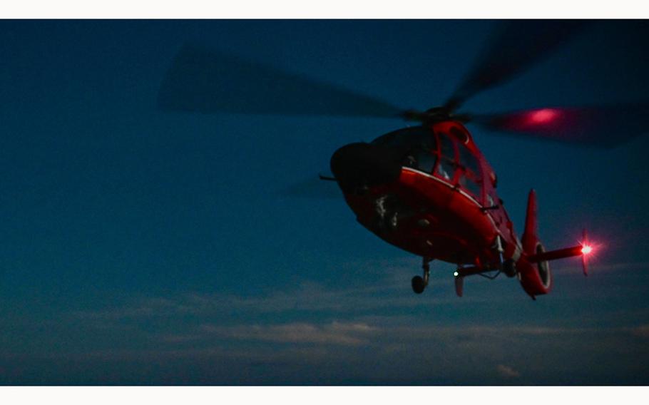 An MH-65 Dolphin flies on a night mission off the coast of Haiti on Nov. 23, 2021. A similar Dolphin helicopter flew off the coast of Oregon in July 2024 on a rescue mission that “was kind of in a different league,” according to a Coast Guard official.