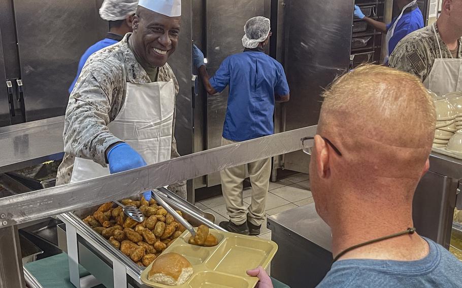 U.S. Marine Corps Gen. Michael E. Langley, Commander of U.S. Africa Command, serves up food 