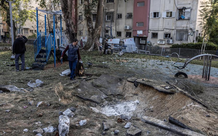 People last week investigate a crater in a Tel Aviv neighborhood left by a missile launched from Yemen. 