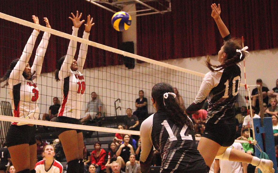 Nile C. Kinnick's Alyssa Staples Jasmine Williams go up to defend a spike by Zama's Emma Sakamoto-Flack during Monday's DODEA-Japan/Kanto Plain volleyball match. The Red Devils won in two sets.