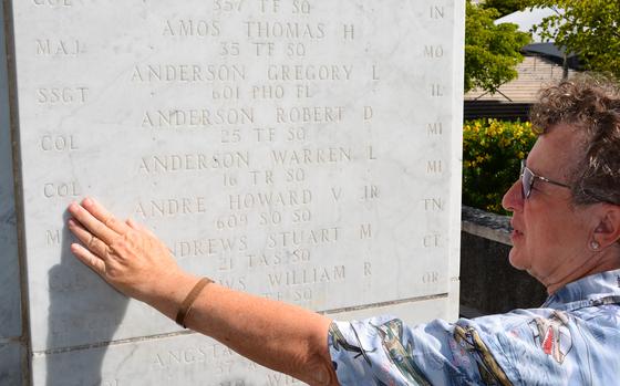 Natalie Rauch points to the name of her father, Col. Warren Anderson, etched in the marble at the Courts of the Missing in the National Memorial Cemetery of the Pacific on June 11, 2024.