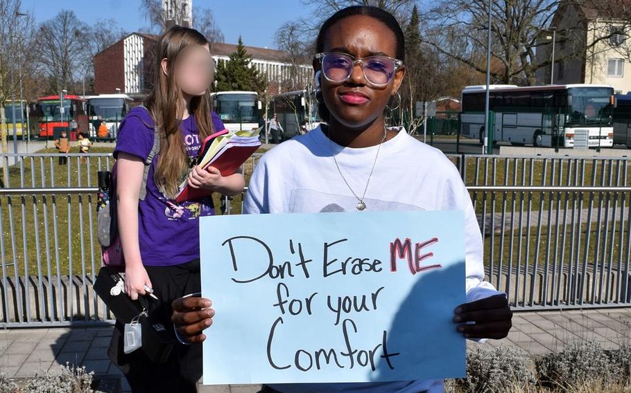 A student holds up a protest sign