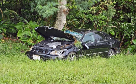 An injured U.S. soldier's damaged sedan sits outside Kadena Air Base, Okinawa, Monday, Aug. 5, 2024.