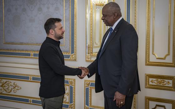 In this photo provided by the Press Service Of The President Of Ukraine on Oct. 21, 2024, U.S. Secretary of Defense Lloyd Austin, right, and Ukraine's President Volodymyr Zelenskyy shake hands during their meeting in Kyiv, Ukraine. (Press Service Of The President Of Ukraine via AP)