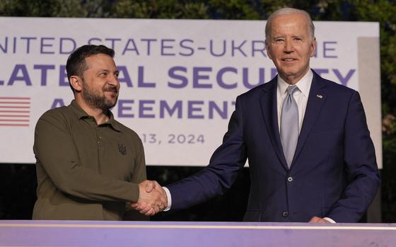President Joe Biden, right, and Ukrainian President Volodymyr Zelenskyy shake hands after signing a bilateral security agreement at the G7 summit in Savelletri, Italy, on June 13, 2024.