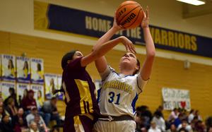 Wiesbaden's Brianna Arroyo goes up against Vilseck's Willa Greenwood during a Jan. 17, 2025, game at Wiesbaden High School in Wiesbaden, Germany.